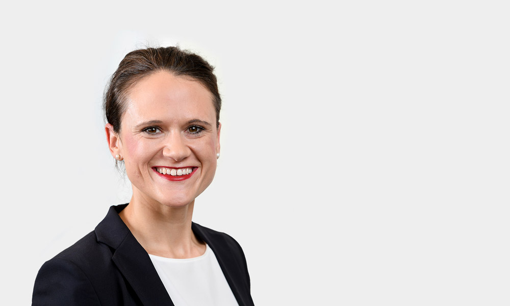 Katharina Oehler, Senior Consultant Portraetfoto von Katharina Oehler vor grauem Hintergrund